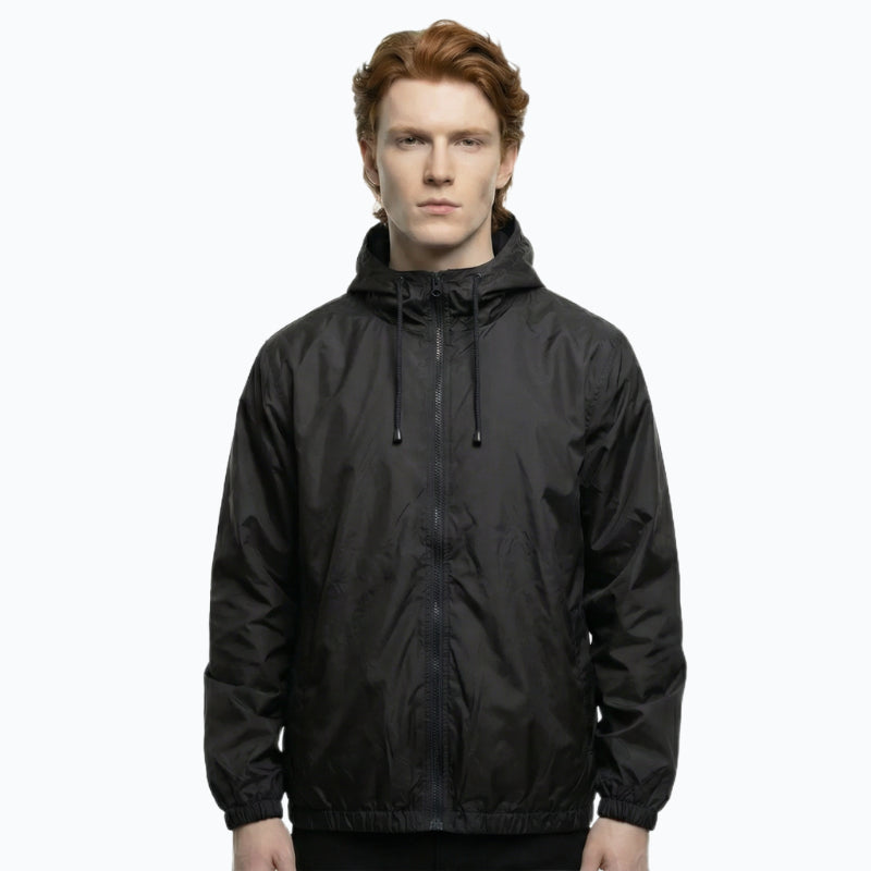 Person wearing a black hooded jacket on a white background