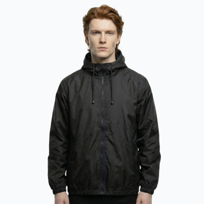 Person wearing a black hooded jacket on a white background